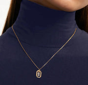 A gold plated initial pendant necklace featuring a shiny letter charm on a delicate chain, adding a personalized and elegant touch to everyday style.